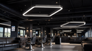 Multiple rounded square LED ceiling lights with glowing outlines in a commercial room