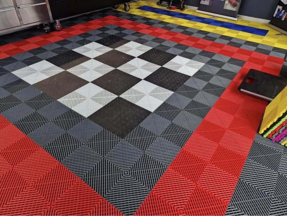 Garage flooring sample tiles with red, yellow, gray, and black checker and geometric patterns