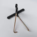 Tile removal tool with black grip, double metal prongs, and long shaft