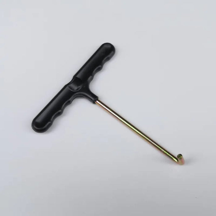 Tile removal tool with black handle and slender metal rod, pointed tip