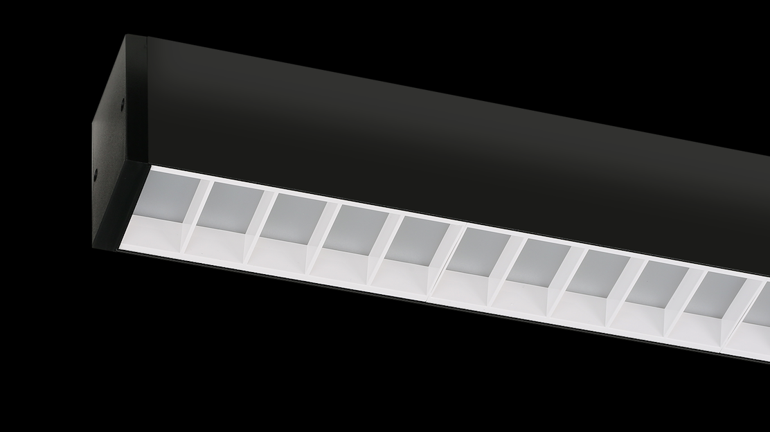 Black linear LED light with vented white diffuser slots inside the housing