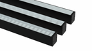 Black linear LED fixture with white ribbed diffuser along the length