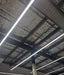 Bright white LED linear light bar on ceiling with mounting brackets